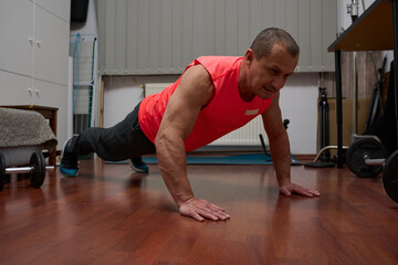 Man doing pushups at home gym