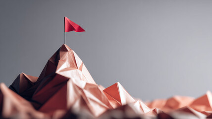 A red flag on the mountain peak. The flag is on top of a mountain made of folded paper and indicates reaching goal