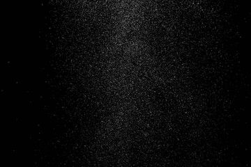 The falling white snow on a black background