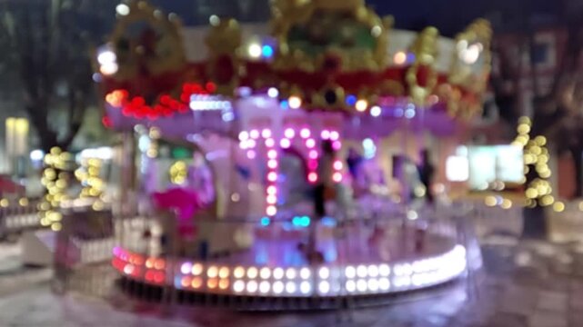 Bokeh abstract for carousel ride in amusement park. Blurred background for Christmas and New Year, 4k