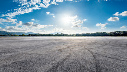 Asphalt race track road and tire track with dramatic sky clouds background