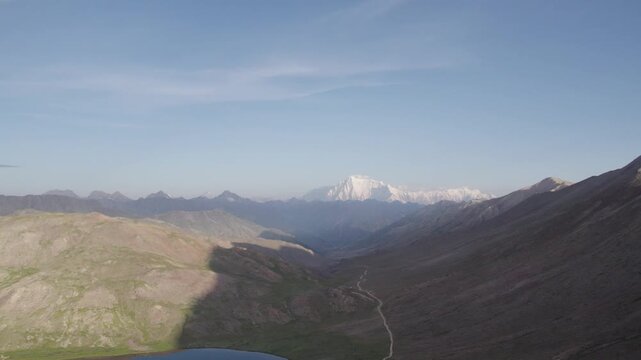 Clear morning view of snow-covered Nanga Parbat towering beyond the Deosai plains under blue skies. Gilgit-Baltistan, Pakistan