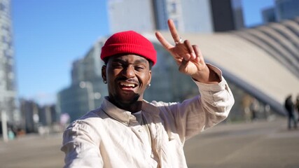 Young black man vlogging and dancing outdoors in the city