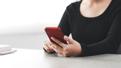 A woman using a smartphone in her room