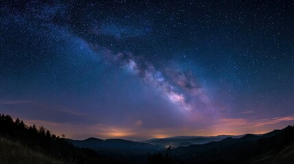 Fototapeta premium Vibrant milky way galaxy arc over distant mountains and glowing horizon