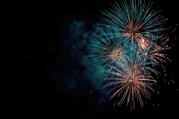 Fototapeta premium Night sky illuminated by bursts of colorful explosions. Abstract art of festive pyrotechnics