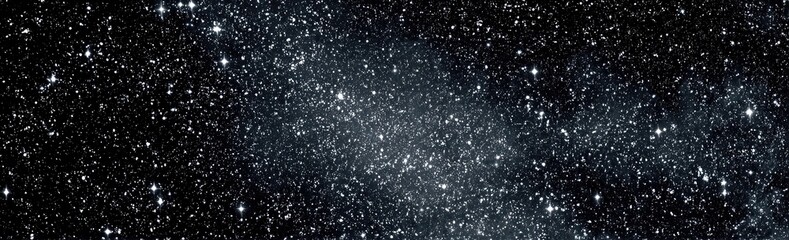 Obraz premium A celestial panorama captures the vastness of space, filled with twinkling stars and nebulous clouds
