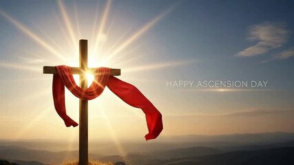 Wooden christian cross draped with flowing red cloth against a brilliant sunrise sky celebrating ascension day