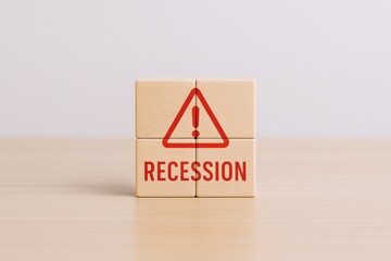 Recession warning sign displayed on wooden blocks symbolizing economic downturn and financial crisis risk
