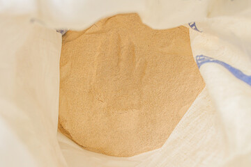 Farmer Proudly Showing Freshly Harvested Soybeans in Hand With Bags Ready for Market