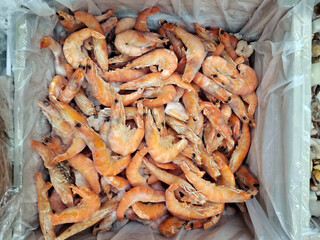 Seafood in a food store. Frozen shrimps in refrigerator