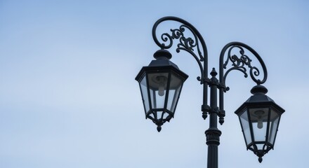 Ornate Streetlight Against Pale Blue Sky: Architectural Detail and Urban Lighting Fixture