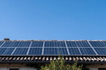 Naklejka premium Solar Panels on House Roof Against Clear Blue Sky in Bright Sunlight