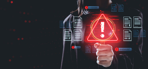 Data breach warning concept with person holding magnifying glass and red alert symbol surrounded by digital files and documents on dark background.
