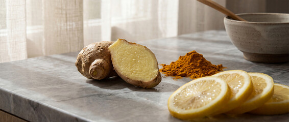 Ginger root and sliced lemon on a sunlit kitchen countertop with turmeric powder, promoting natural wellness and immune system support