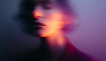 Artistic blurred portrait featuring vibrant orange and purple lighting, creating a dreamy, ethereal atmosphere with soft focus.