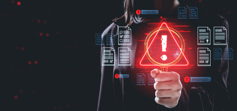 Data breach warning concept with person holding magnifying glass and red alert symbol surrounded by digital files and documents on dark background.