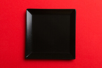 Top view of isolated of colored background empty square black plate for food. Empty dish with space for your design