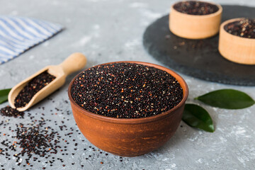quinoa seeds in bowl and spoon on colored background. Healthy kinwa in small bowl. Healthy superfood