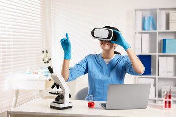 Modern technology. Doctor with headset using virtual screen at desk in office. Space for text