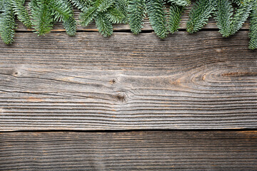 Christmas or New Year background with a border of green fir tree branches. Rustic wooden Ornament Border Background