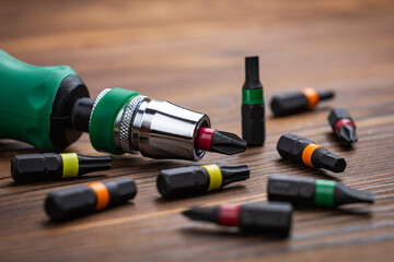 Screwdriver tips different shapes and sizes. Manual screwdriver and set of the interchangeable bits.
