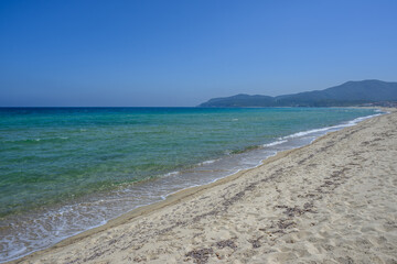Empty shoreline without people and turquoise water at Sarti Beach, Greece