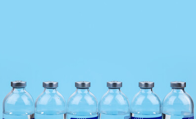 medical bottle for IV drip on blue background