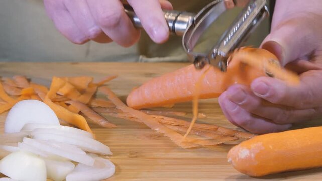 Peel a carrot with a vegetable peeler