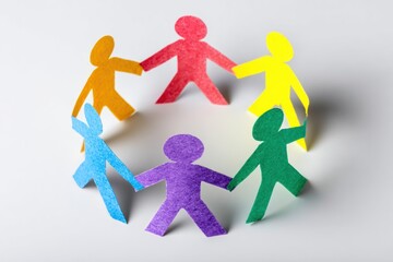 Diverse paper people chain symbolizing unity, teamwork, and community connection.
