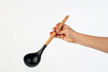 Black plastic spatula in hand on white background