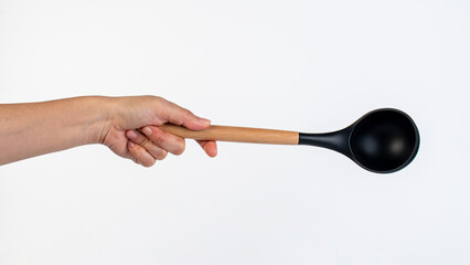 Black plastic spatula in hand on white background