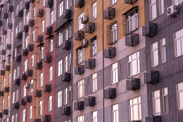 Colorful Apartment Facade with Repeating Air Conditioners and Window Patterns