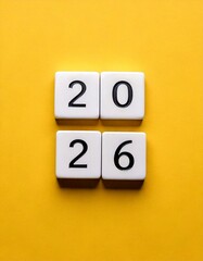 2026, numbers on white letter tiles, isolated on yellow background, copy space for text, 20 seperated on top of 26