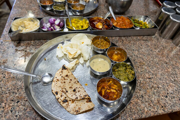 traditional indian lunch thali showcasing multiple curries and sides