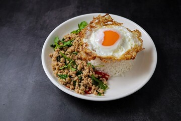 Stir-fried minced chicken with holy basil served with steamed rice and fried egg.