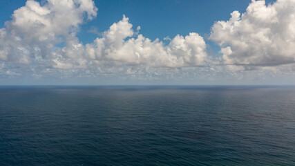 Blue sea and sky with clouds, view from the drone. Summer and travel vacation concept. Flight over the sea.