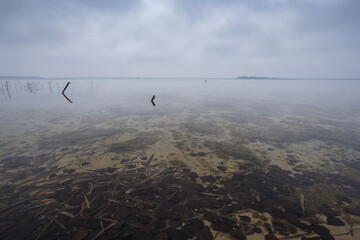 Lake in windy and cloudy weather. Autumn