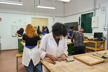 Students learning jewelry crafting in art workshop