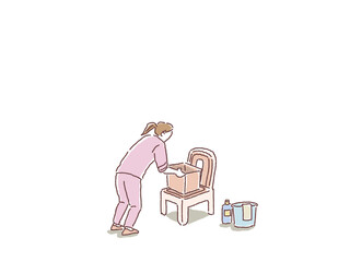 ポータブルトイレのバケツを取り出す看護師、介護士、ヘルパーの女性の後ろ姿