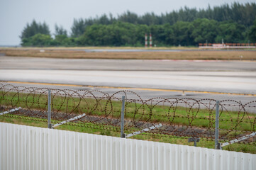 Razor wire and fence protecting an airport runway