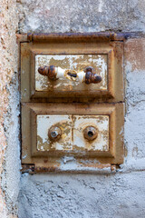 Authentic industrial and rustic charm in this old cast iron cleanout door, featuring original handles and a richly rusted surface. 