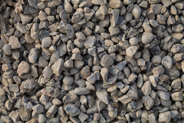 Crushed rock close up. Small rocks ground. Crushed stone road building material gravel texture. Small stone construction material rock. Garden gravel background stone landscaping. Driveway gravel road