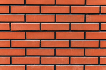 Obraz premium Brick wall with a red brick color. The wall is very long and has a lot of bricks