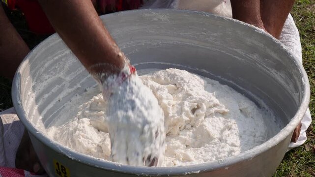 person making a paste for bori, bori is made by urad dal and winter melon which is sun dried