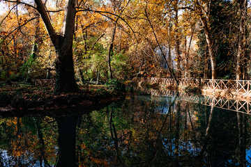 Wooden bridge and reflections in the water at Monasterio de Piedra, Spain