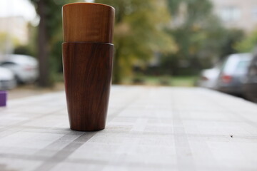 Elegant handmade wood water glass or wooden cup isolated on white background.