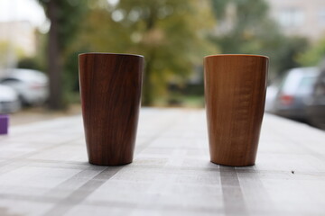 Elegant handmade wood water glass or wooden cup isolated on white background.