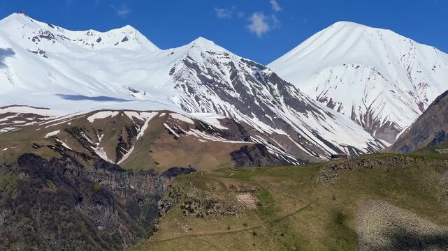 GUDAURI, GEORGIA - APRIL 26, 2024: Scenic view of the Devil's Gorge and the Arch of Friendship. The Caucasus Mountains in the area of the Peoples' Friendship Arch on the Georgian Military Road. 4K