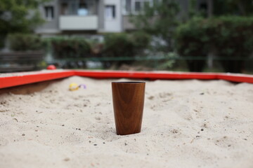 Elegant handmade wood water glass or wooden cup isolated on white background.